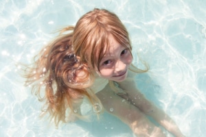 Kleinkind im seichten Poolwasser