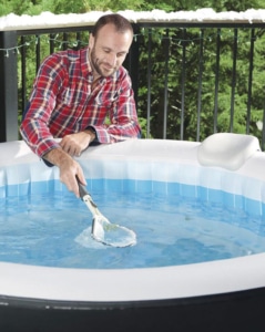 Mann reinigt seinen Whirlpool mit dem Kescher des LAY-Z-SPA® Reinignungs-Set All in One