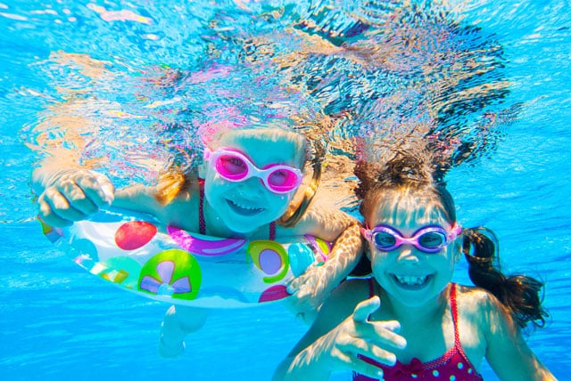 Kinder tauchen im großen Pool unter Wasser